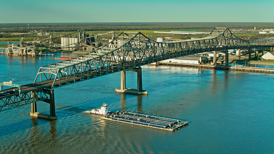 Aerial view of Horace Wilkinson Bridge and industrial area across the Mississippi River in Baton Rouge, Louisiana. \n\nAuthorization was obtained from the FAA for this operation in restricted airspace.
