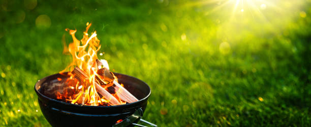 istock Barbecue Grill with Open Fire on Green Grass 1395789859