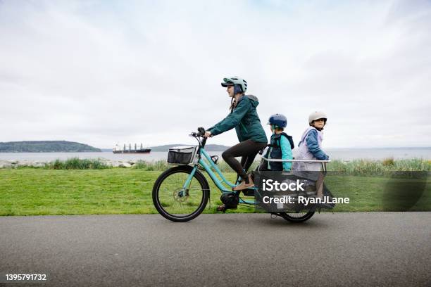 Bike Ride On Cargo Ebike Carries The Whole Family Stock Photo - Download Image Now - Electric Bicycle, Cargo Bike, Family