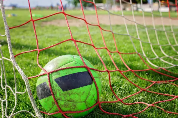 Photo of Soccer gears on green grass prepared for training in kids football academy. Popular sport activity