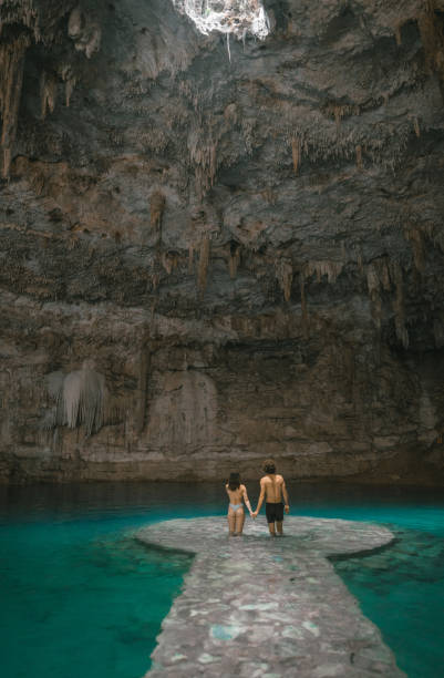 istock Couple standing  in Cenote in Yucatan, Mexico 1395795512
