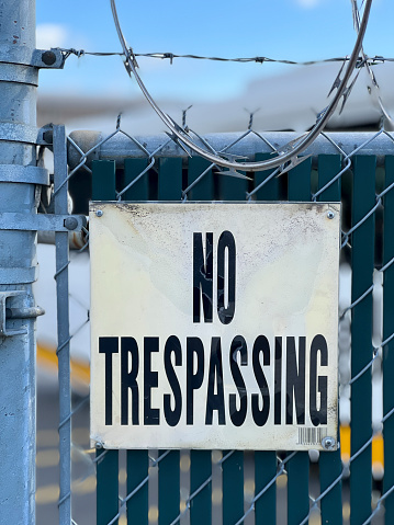 No Trespassing Sign On Fence with Barbed Wire in Seattle, Washington, United States