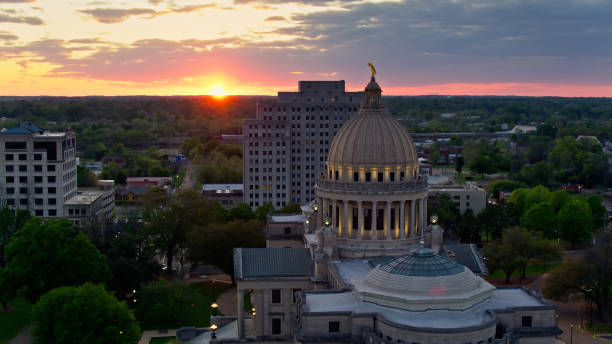 istock Sun Meets Horizon Behind Mississippi State Capitol at Dusk 1395796412