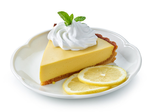 slice of lemon tart on white plate isolated on white background