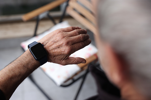 Senior man checking health monitor on smart watch
