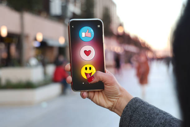 Woman using mobil phone with emoji