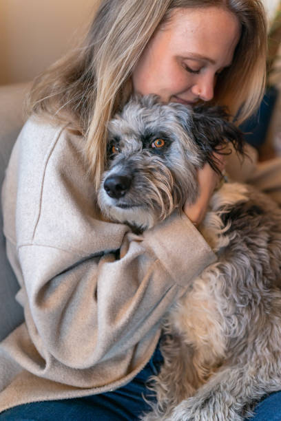 istock Young woman embracing loyal and affectionate pet dog 1395805237