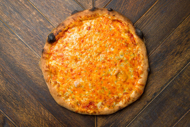 istock Pizza Quattro formaggi on wooden table top view 1395805862