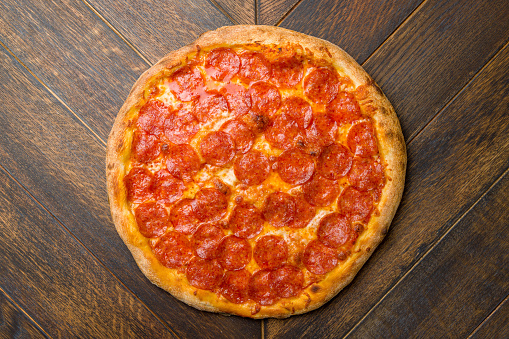 Pepperoni pizza on wooden table top view
