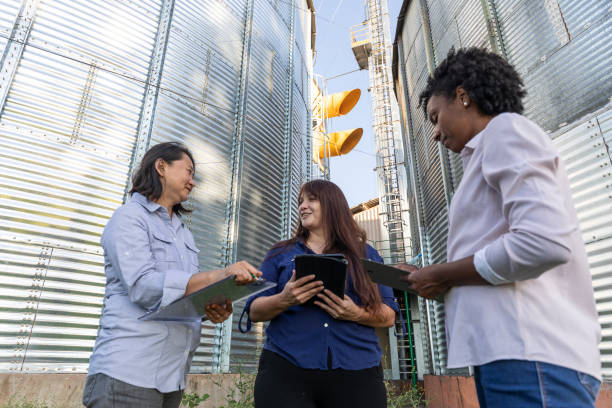 istock Women of various ethnicities engineers working in a grain silo 1395807750