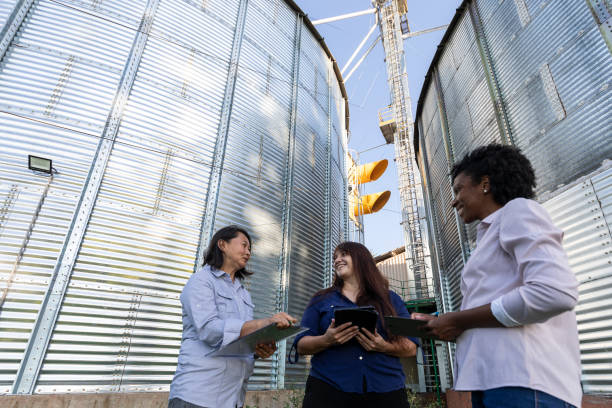 Women of various ethnicities engineers working in a grain silo