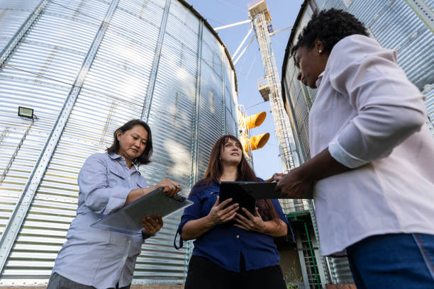 istock Women of various ethnicities engineers working in a grain silo 1395808548
