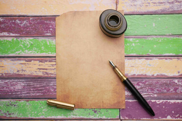 old empty paper and fountain pen on table .