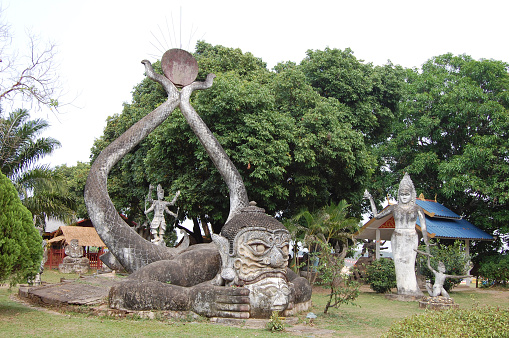 Surreal statues at Buddha Park, also known as Xieng Khuan, a sculpture park 25 km southeast from Vientiane, Laos in a meadow by the Mekong River.