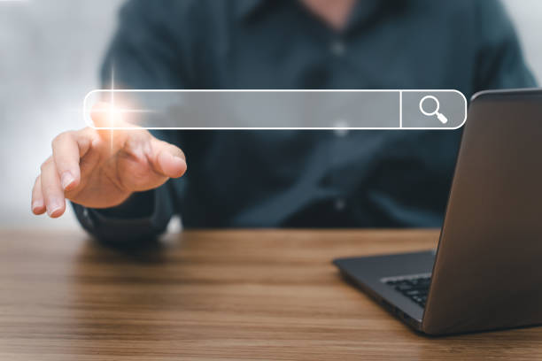 istock Searching information data on internet networking concept. Man point on Searching screen and use Laptop working on the table with texture and copy space 1395832460