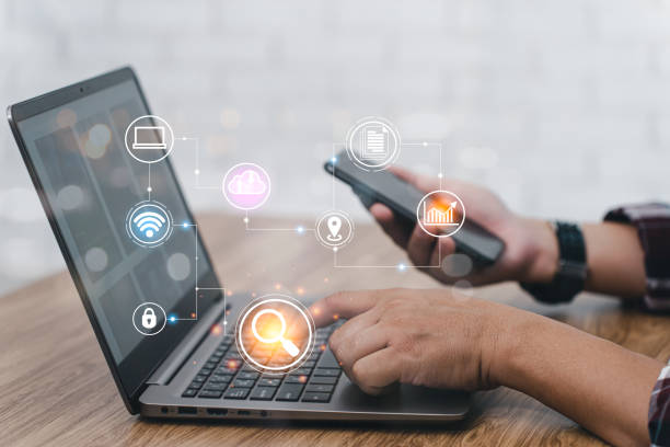 istock Searching information data on internet networking concept. Man uses laptop searching in cloud technology data storage and uses smartphone connect to internet, texture and copy space 1395832462
