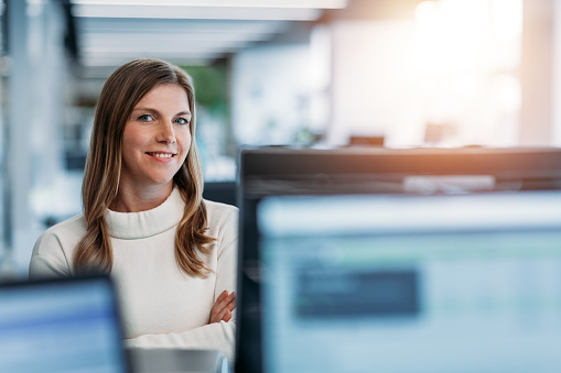 Portrait of woman smiling in modern business office