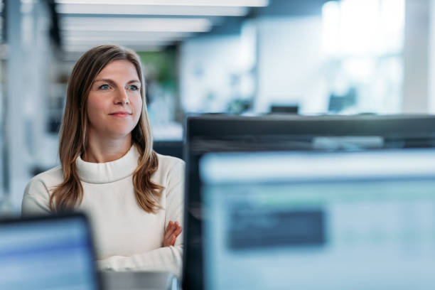 istock Portrait of woman looking forward in thought in modern technology office looking forward ahead and thinking 1395838903