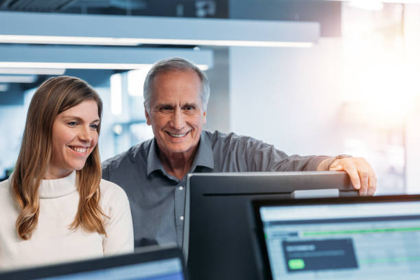 istock Colleagues collaborating in modern office and looking at computer monitor 1395838966