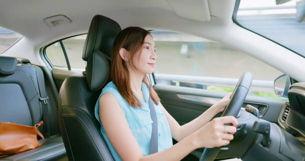 istock asian young woman driving car 1395843133
