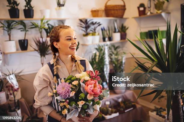 Mother And Daughter Taking Care Of The Plants In Their Floral Shop Stock Photo - Download Image Now