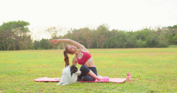istock girl practice yoga with dog 1395844082