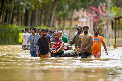 Alleppey, Kerala,India - August 24 2018: Rescue team help people to escape from flooded area
