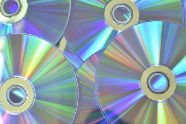 cd or dvd with colorful light reflection on surface in white background - dvd obsolete cd cd rom imagens e fotografias de stock