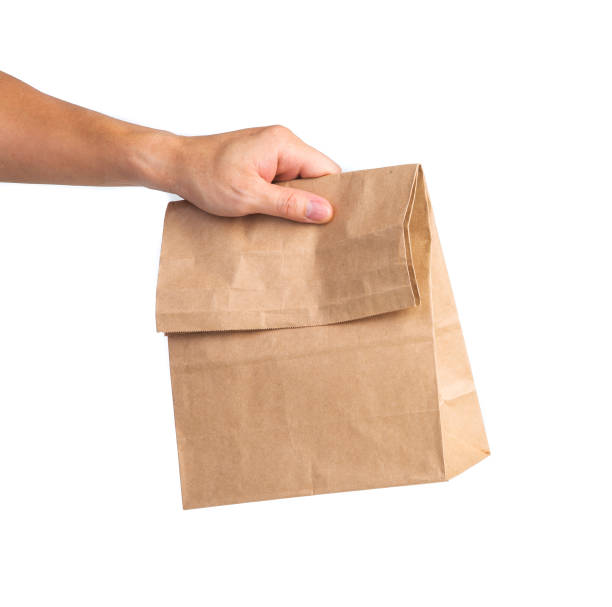 istock Man holding a brown paper bag 1395848110