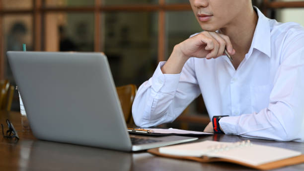 istock Focused young male employee analyzing financial data on computer laptop. 1395850216