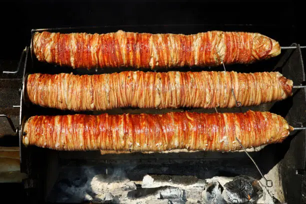 Photo of grilled Turkish food kokoreç on the grill