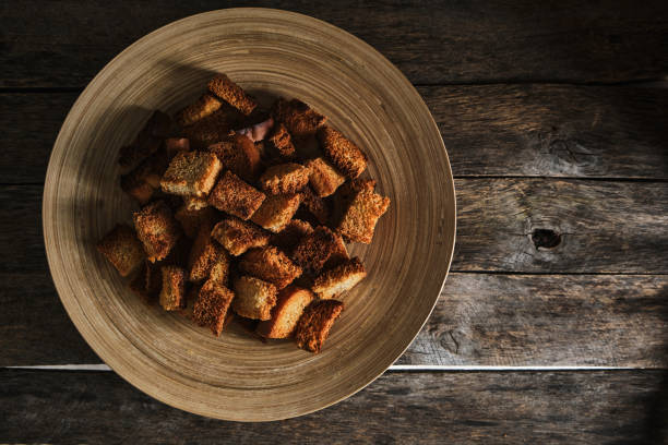 istock Plate breadcrumbs on an old wooden table, top view. 1395852206