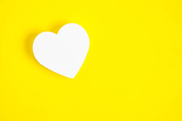 istock White heart yellow background.Festive background for Valentines Day. 1395852302