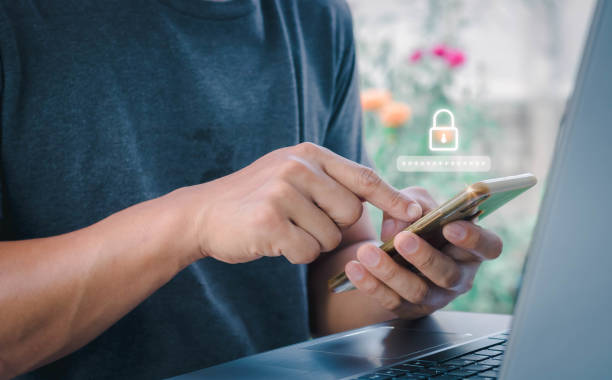 istock Asian businessman using the smart mobile phone to access on phone with laptop for validate password for biometric two steps authentication to unlock security, Business Technology security Concept 1395853601