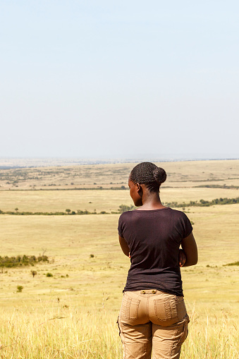 Maasai mara, Kenya - February 07, 2016: Young African woman at the savanna