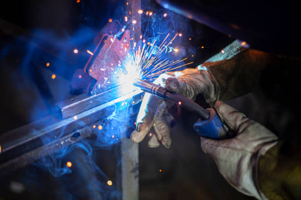 Metal welding. Fire from operation of welding machine. Manufacture of steel seam. Processing of steel profile. Sparks from welding. stock photo