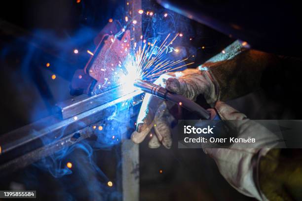 Metal Welding Fire From Operation Of Welding Machine Manufacture Of Steel Seam Processing Of Steel Profile Sparks From Welding Stock Photo - Download Image Now