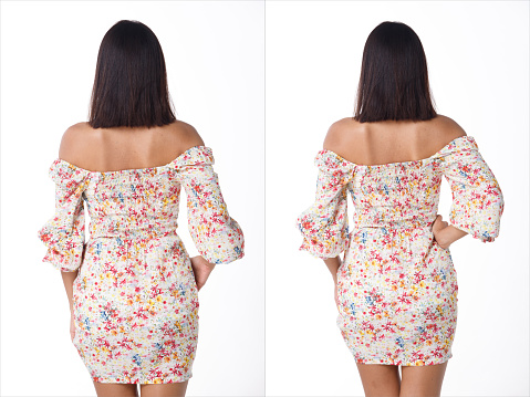 Back side rear view of Woman head in short black hair and tanned skin female wear pattern dress, half body over white background isolated