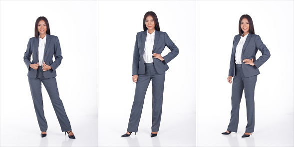 Full length Portrait of 20s Asian business Woman black short hair white shirt gray suit pant shoes. Female express feeling smart smile over white Background isolated