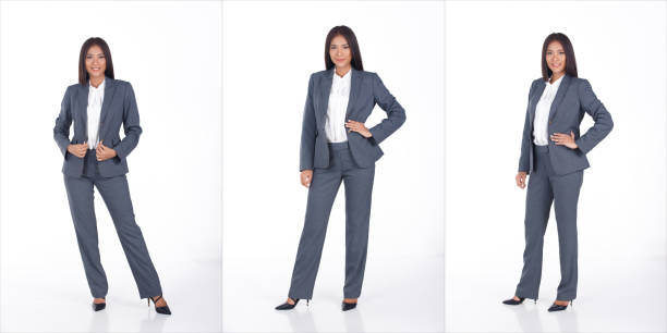 full length portrait of 20s asian business woman black short hair white shirt gray suit pant shoes - fato de senhora imagens e fotografias de stock