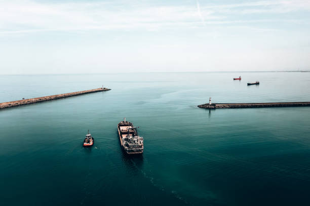 Aerial view of cargo ship leaving port.