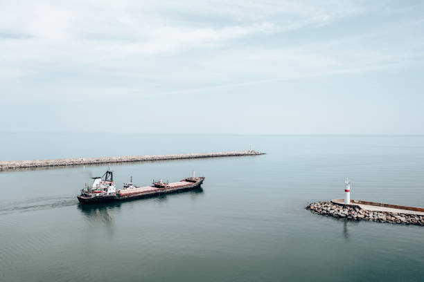 istock Aerial view of cargo ship leaving port. 1395859559
