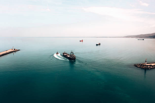 istock Aerial view of cargo ship leaving port. 1395859610