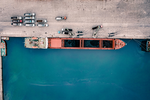 Cargo ship unloading of coal in a commercial port. Samsun, Turkey.