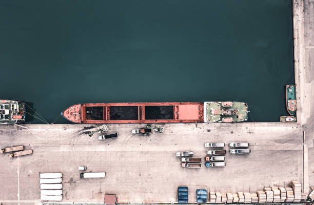 istock Cargo ship unloading of coal in a commercial port. 1395861091