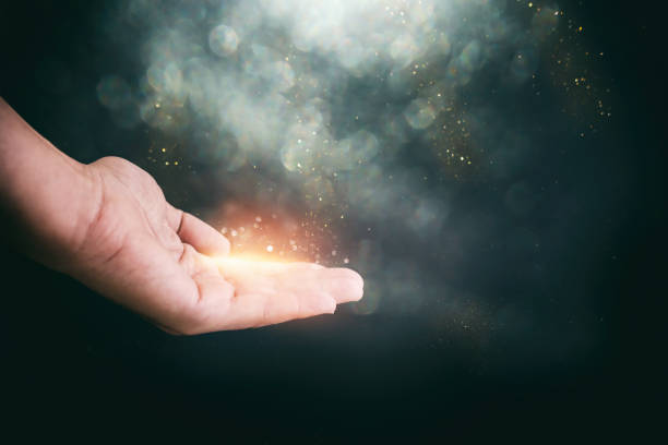 istock Human hand and magical glowing light 1395861935