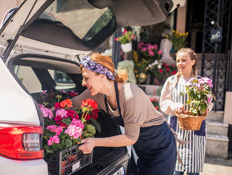 florist placing flowers in car