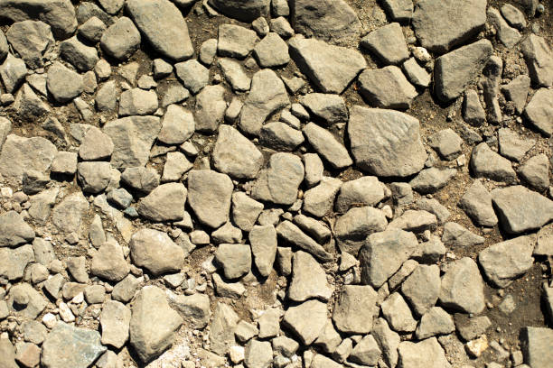 Small stone on road. Lots of stones. Texture of old road.