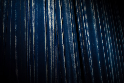 Blue curtain in theater. Details of concert curtain. Blue fabric.
