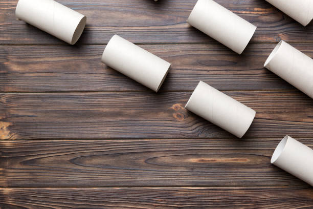 istock Flat lay composition with empty toilet paper rolls and space for text on color background. Recyclable paper tube with metal plug end made of kraft paper or cardboard 1395865460
